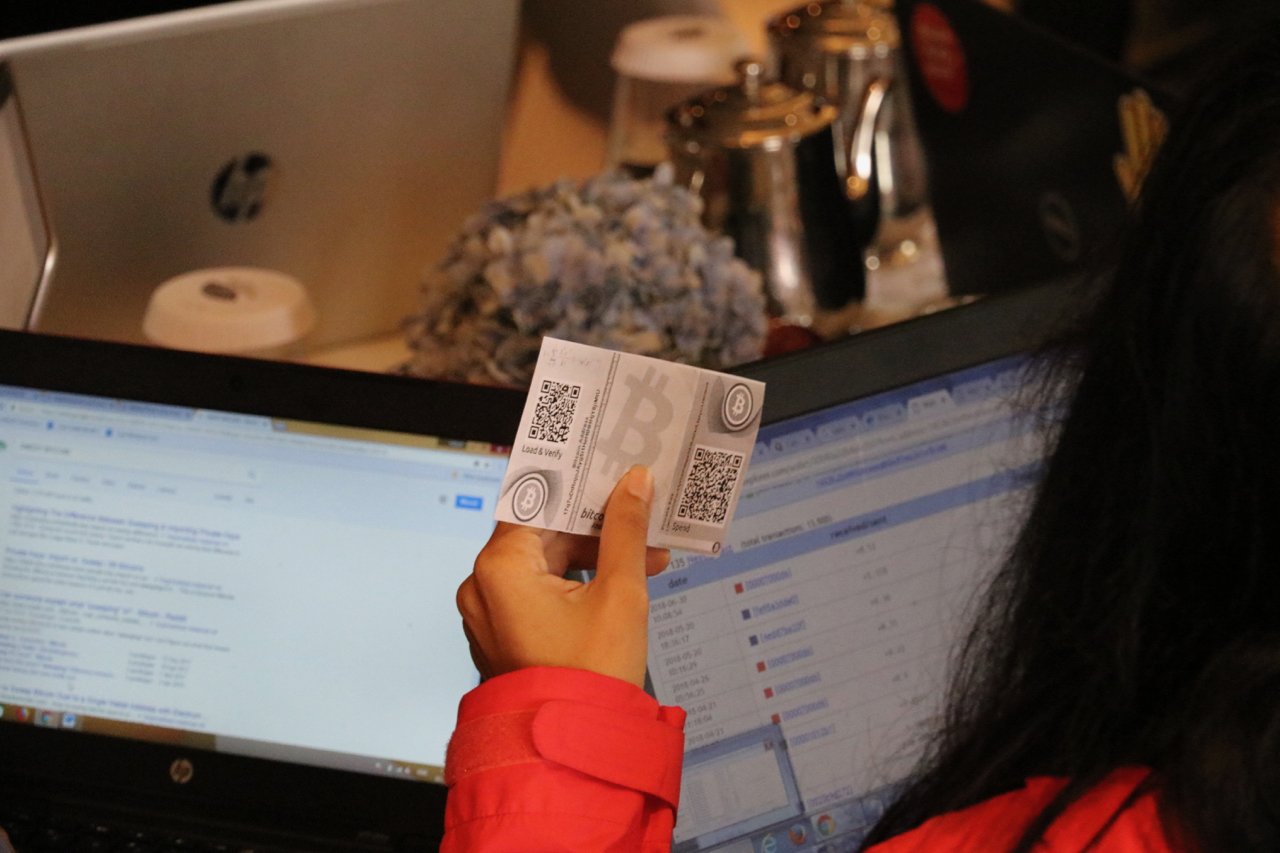 Student holds a Bitcoin voucher