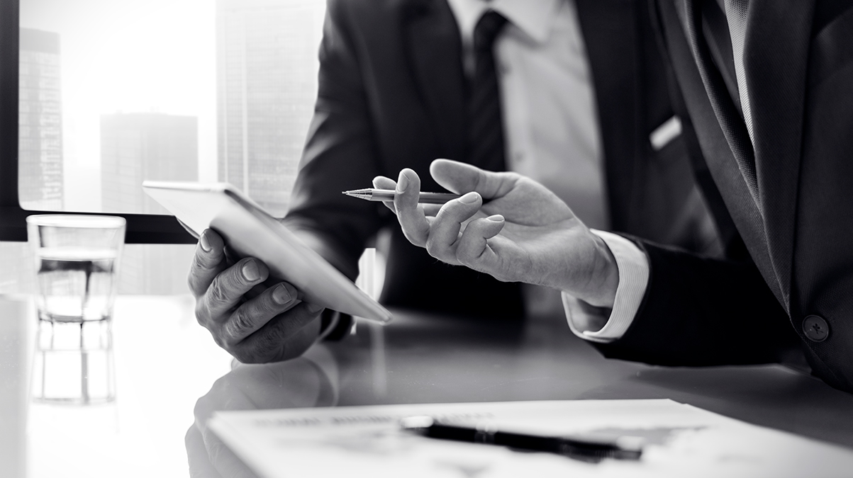 Two men discussing something written on a notepad