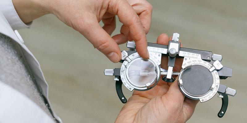 Hands holding a vision testing device